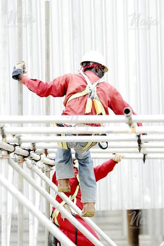 OIL AND GAS WORKER CLIMBING SCAFFOLD