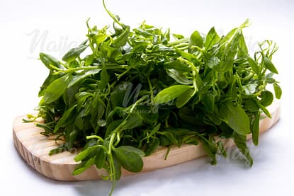 WATER LEAF/ SPINACH ON A WOODEN BOARD