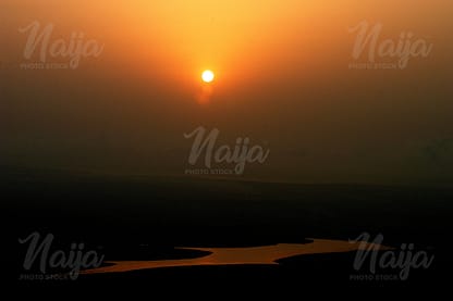 SUNSET OVER A SMALL POOL OF WATER