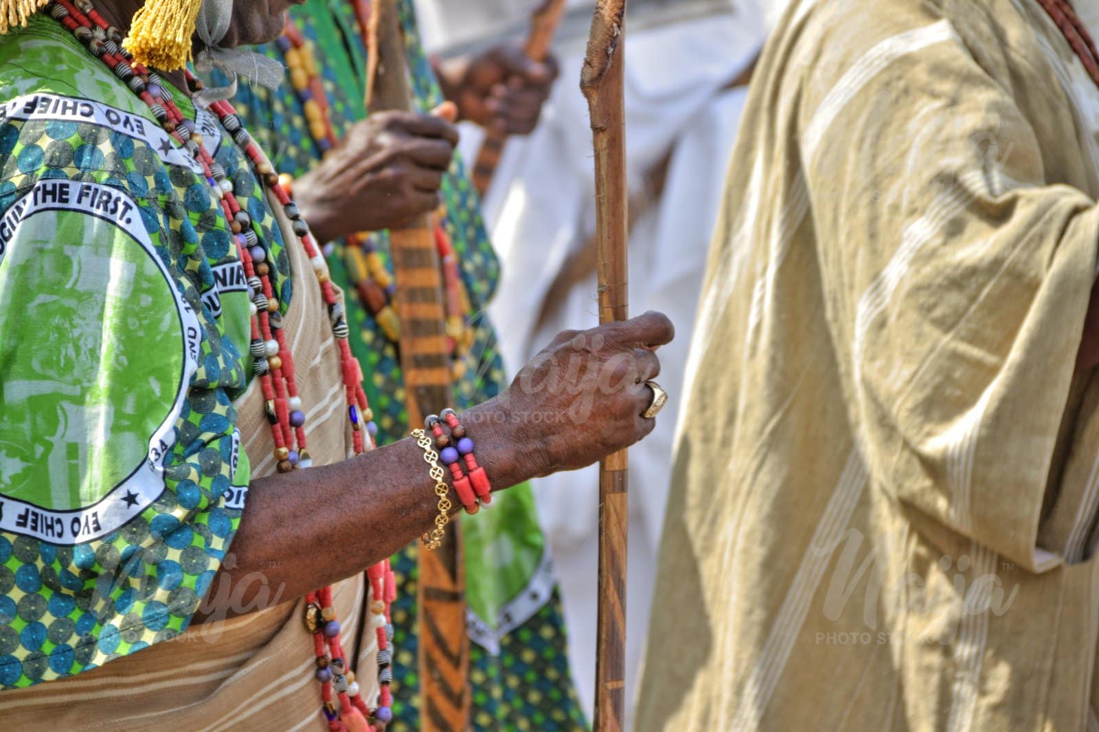 MAN HOLDING A STAFF AT THE LAGOS EYO FESTIVAL