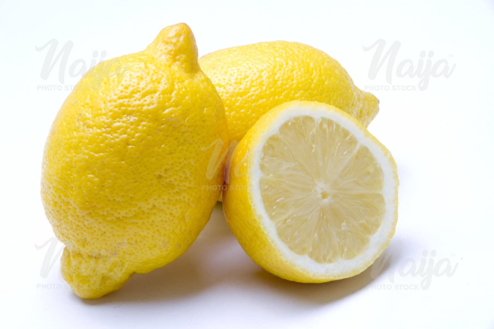 2 LEMONS AND ONE SLICED OPEN - DIAGONAL VIEW