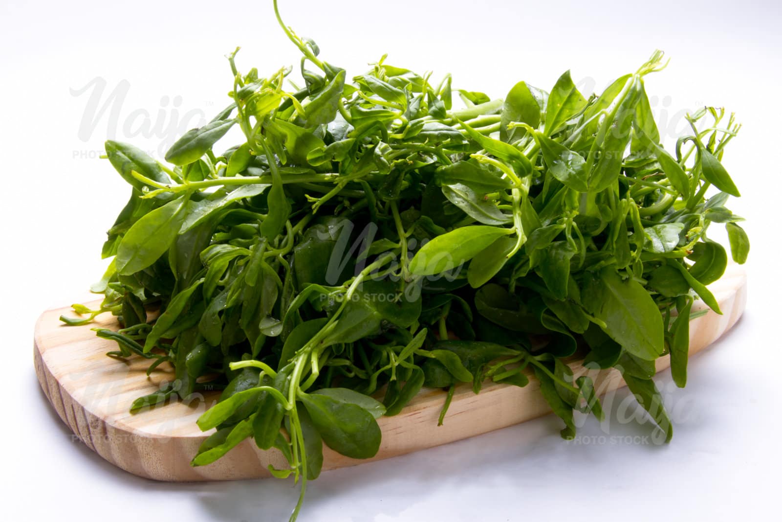 WATER LEAF/ SPINACH ON A WOODEN BOARD